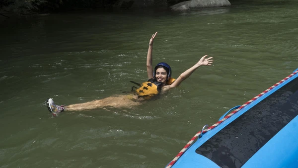 Smiling woman floating on the santo domingo river, expedition colombia,